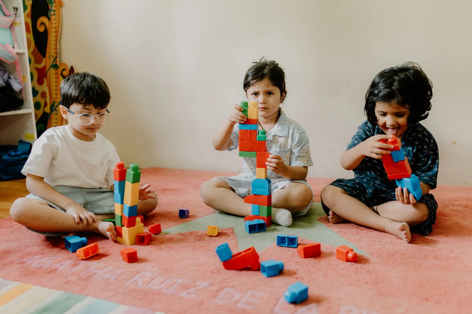 Children building towers with colourful blocks