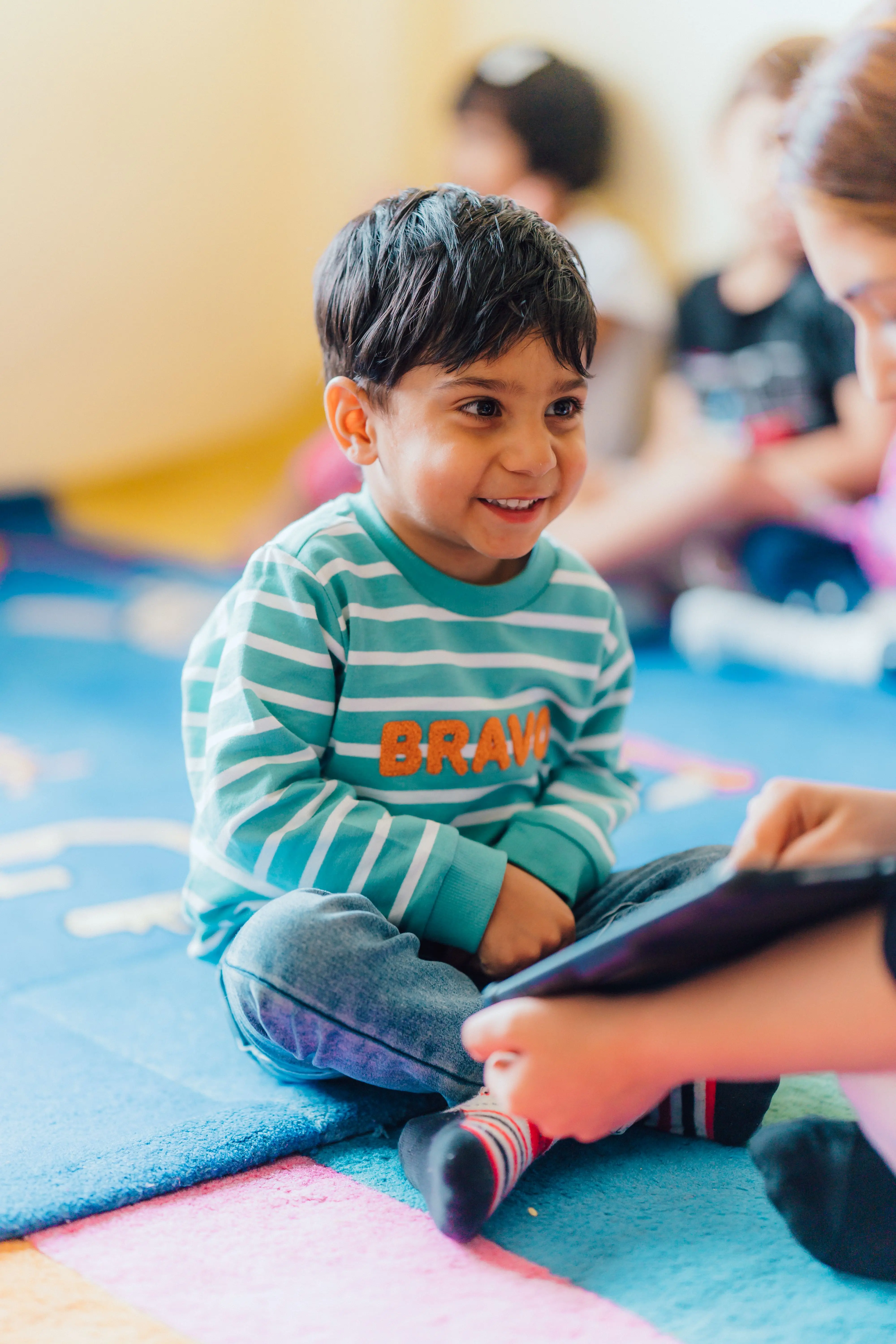 A dedicated teacher enjoying a reading session with a young child